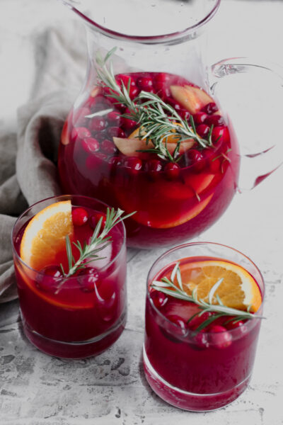 Pitcher and two glasses of Cranberry Orange Holiday Sangria