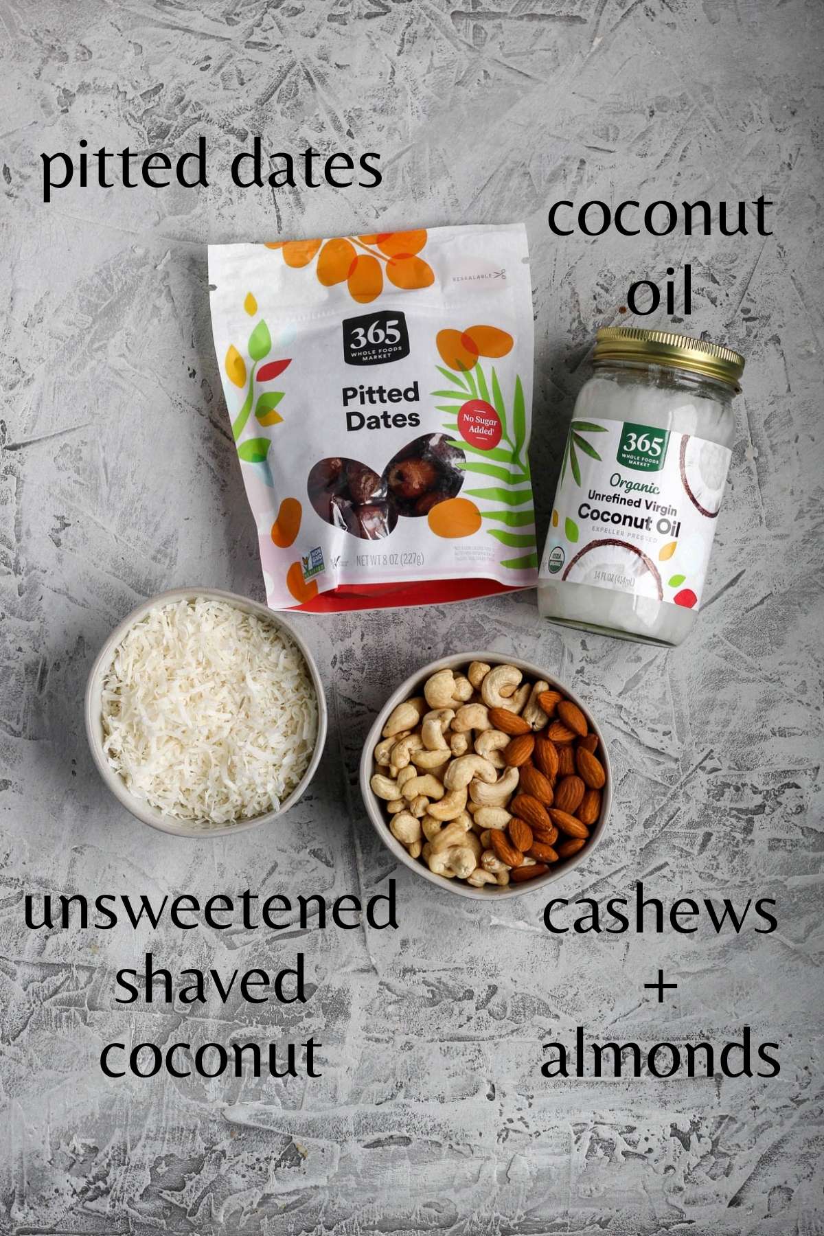 a bag of pitted dates, a jar of coconut oil, a bowl of unsweetened shaved coconut, and a bowl of cashews and almonds