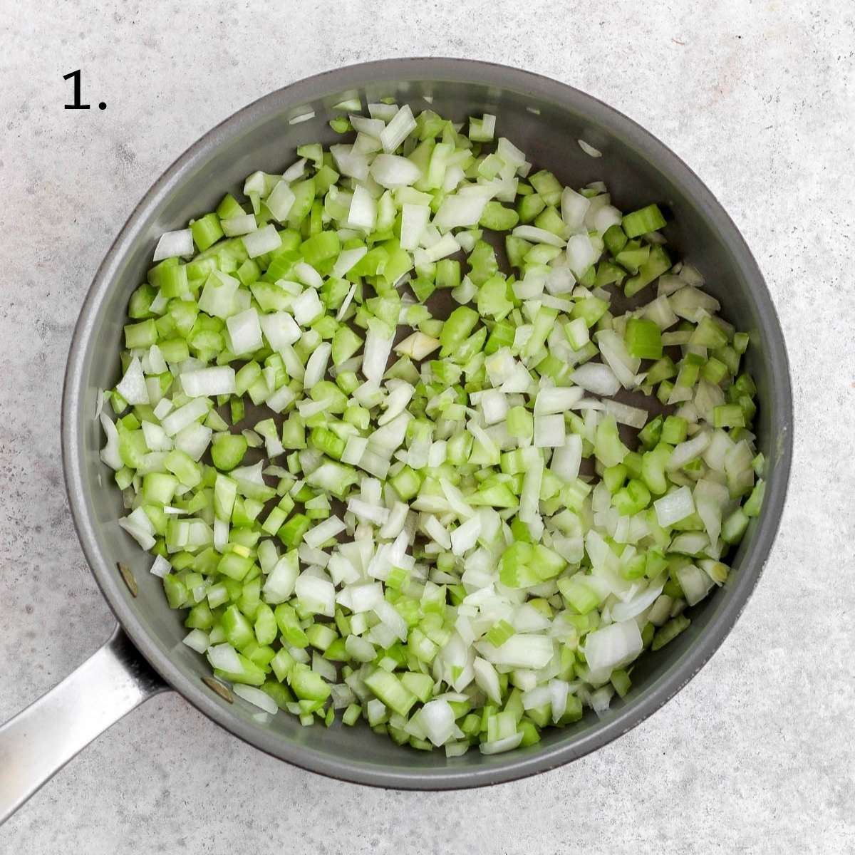 A pan with diced celery and diced onion inside.