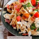 A Pinterest pin with a dark green plate filled with BLT Chicken Salad.