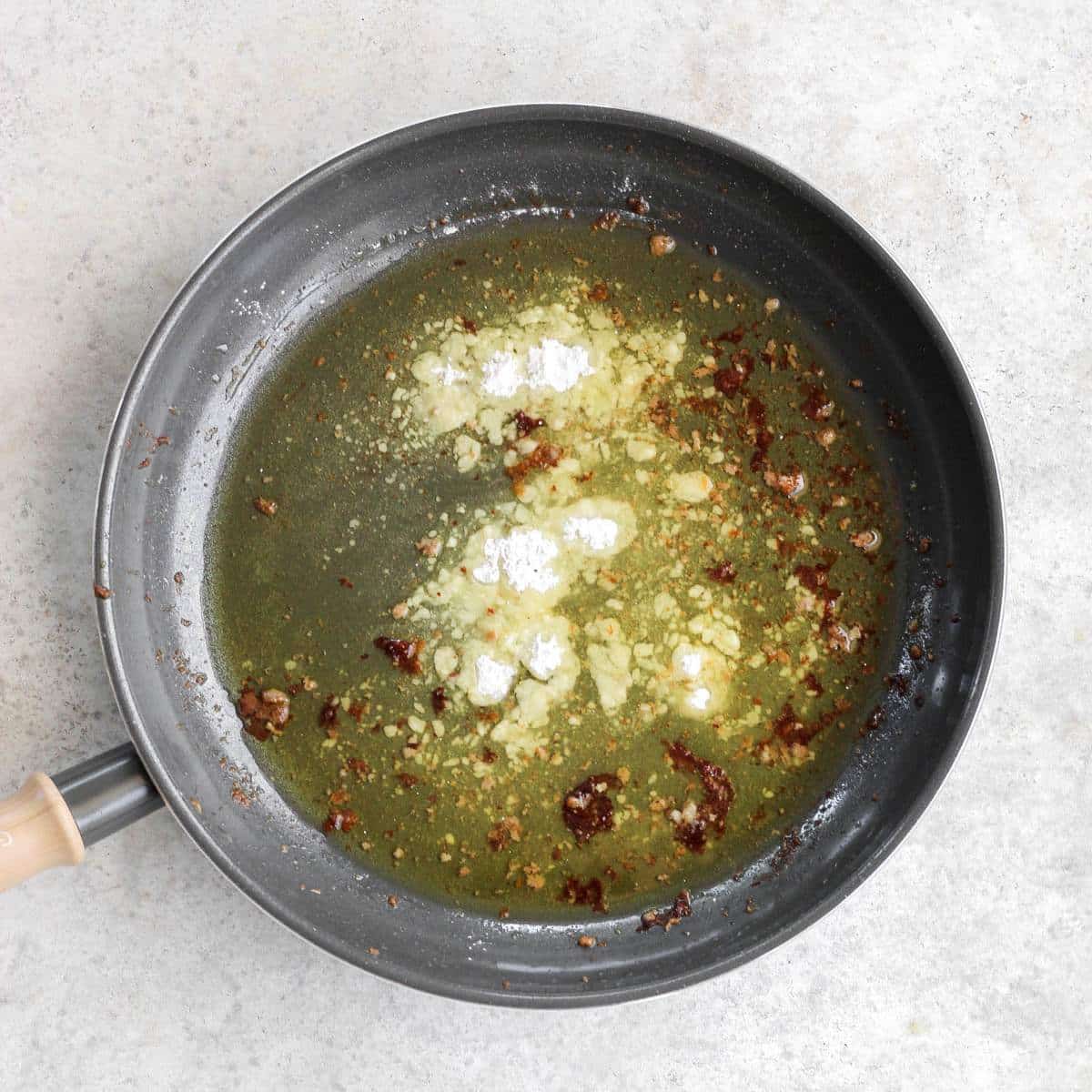 A pan with melted ghee, and arrowroot flour in it.