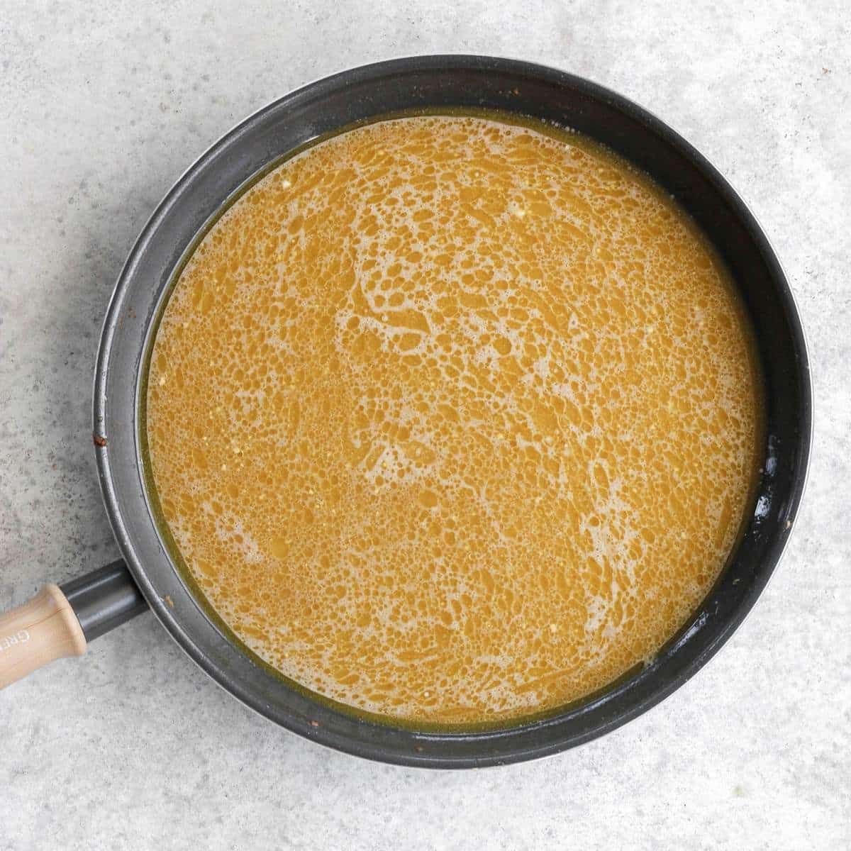 A pan filled with dairy free gravy.