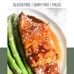 A Pinterest poster with piece of citrus glazed air fryer halibut with sesame seeds on top on a plate with asparagus.