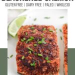 A Pinterest poster of a filet of baked blackened salmon on a plate with chives sprinkled around.