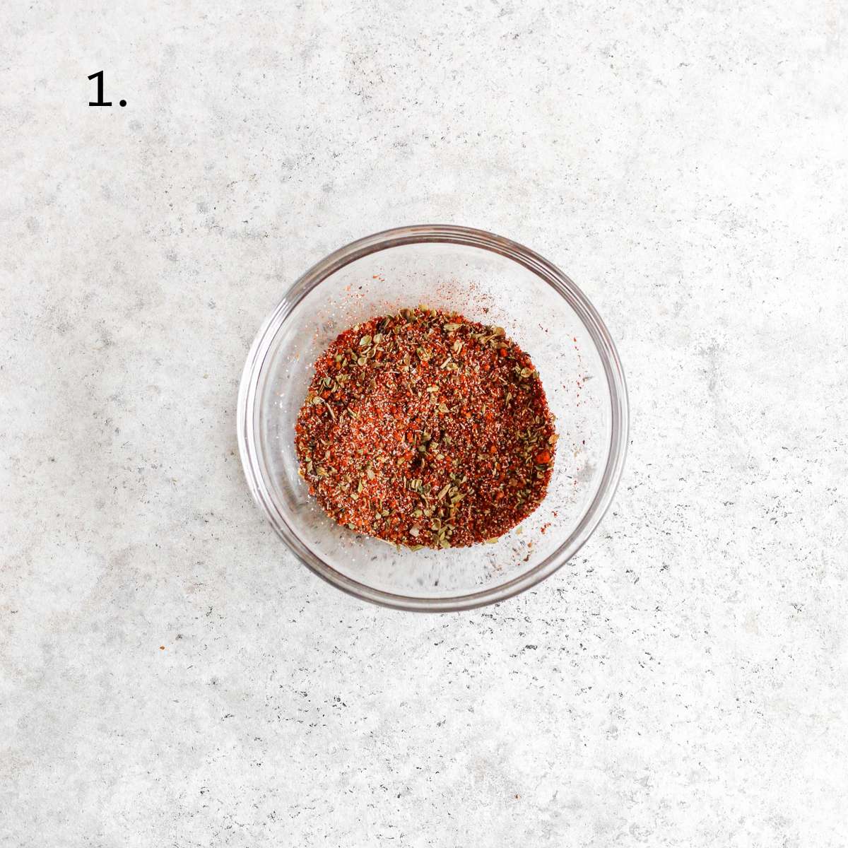 A small glass bowl with the spices needed to make blackened salmon.