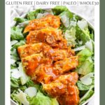 A Pinterest pin poster of buffalo chicken laying on top of caesar salad.