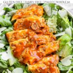 A Pinterest pin poster of buffalo chicken laying on top of caesar salad.