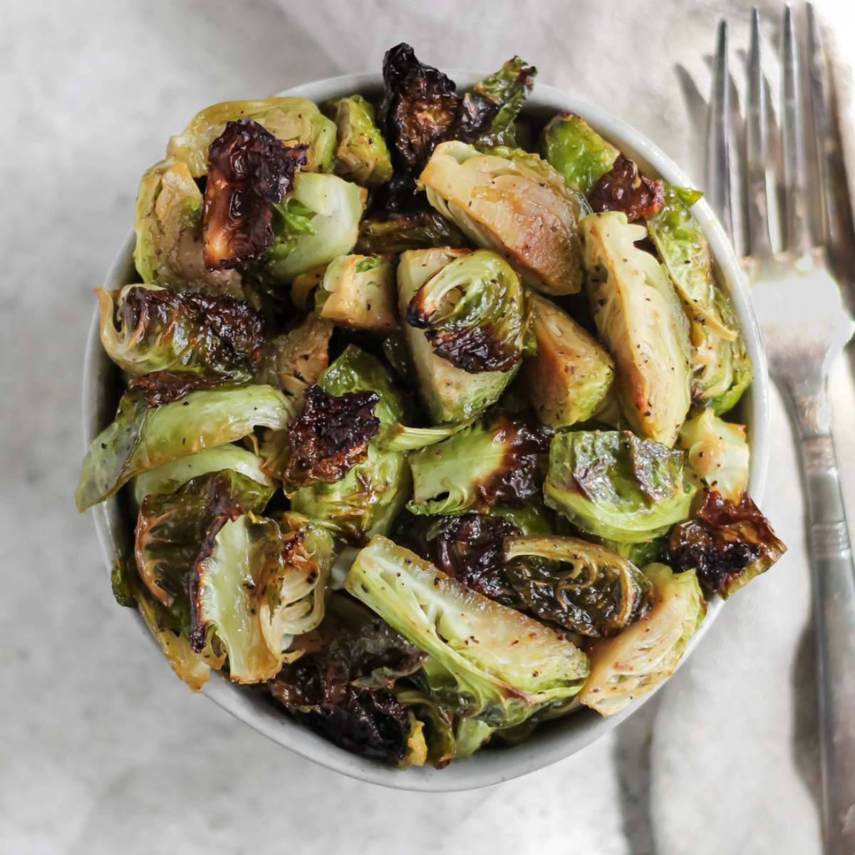A bowl filled with hot honey roasted brussel sprouts.