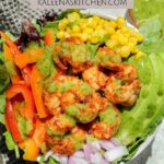 A Pinterest Pin poster with Blackened Shrimp Salad with Cilantro Lime dressing in a bowl with a black tea towel off to the side.