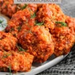A Pinterest Pin poster with crispy buffalo shrimp on a plate with a side of ranch and a black and white tea towel next to the plate.