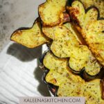 A Pinterest pin with air fryer acorn squash sitting in a white oval serving dish with a white tea towel underneath.
