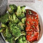 Air fryer teriyaki salmon sitting on a plate next to roasted broccoli.