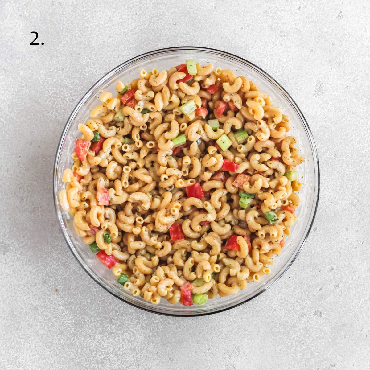A bowl with buffalo ranch protein pasta salad all mixed together.