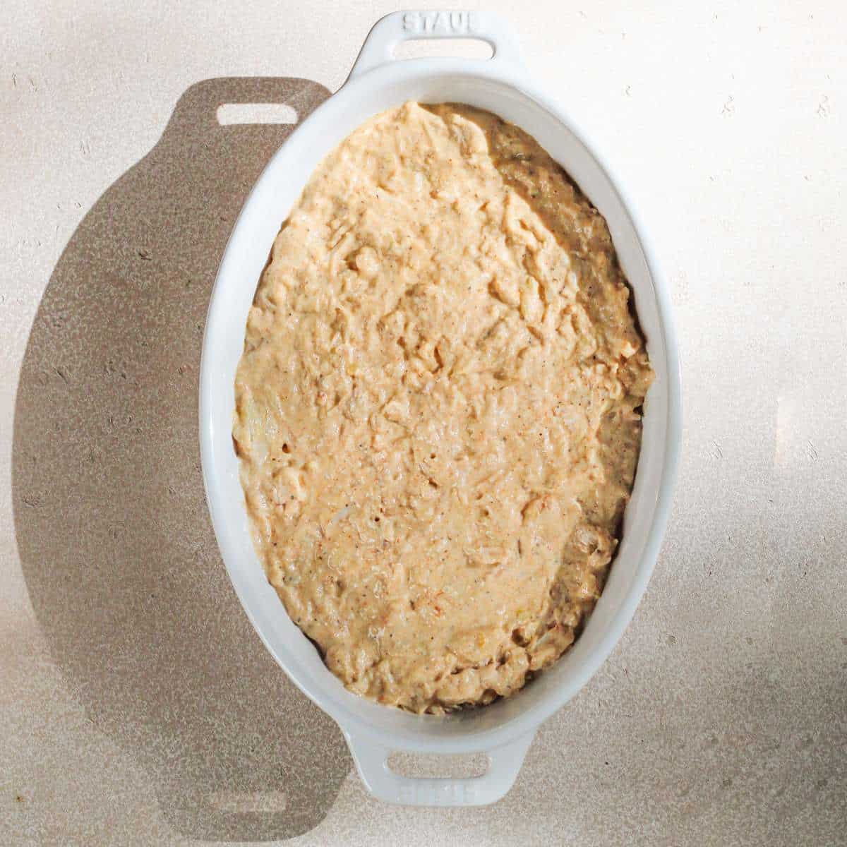 A white oval serving dish filled with dairy free crab dip.