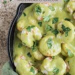 A Pinterest pin poster with creamy poblano shrimp in a cast iron skillet with cilantro sprinkled on top.