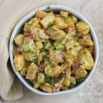 A white bowl filled with buffalo ranch potato salad.