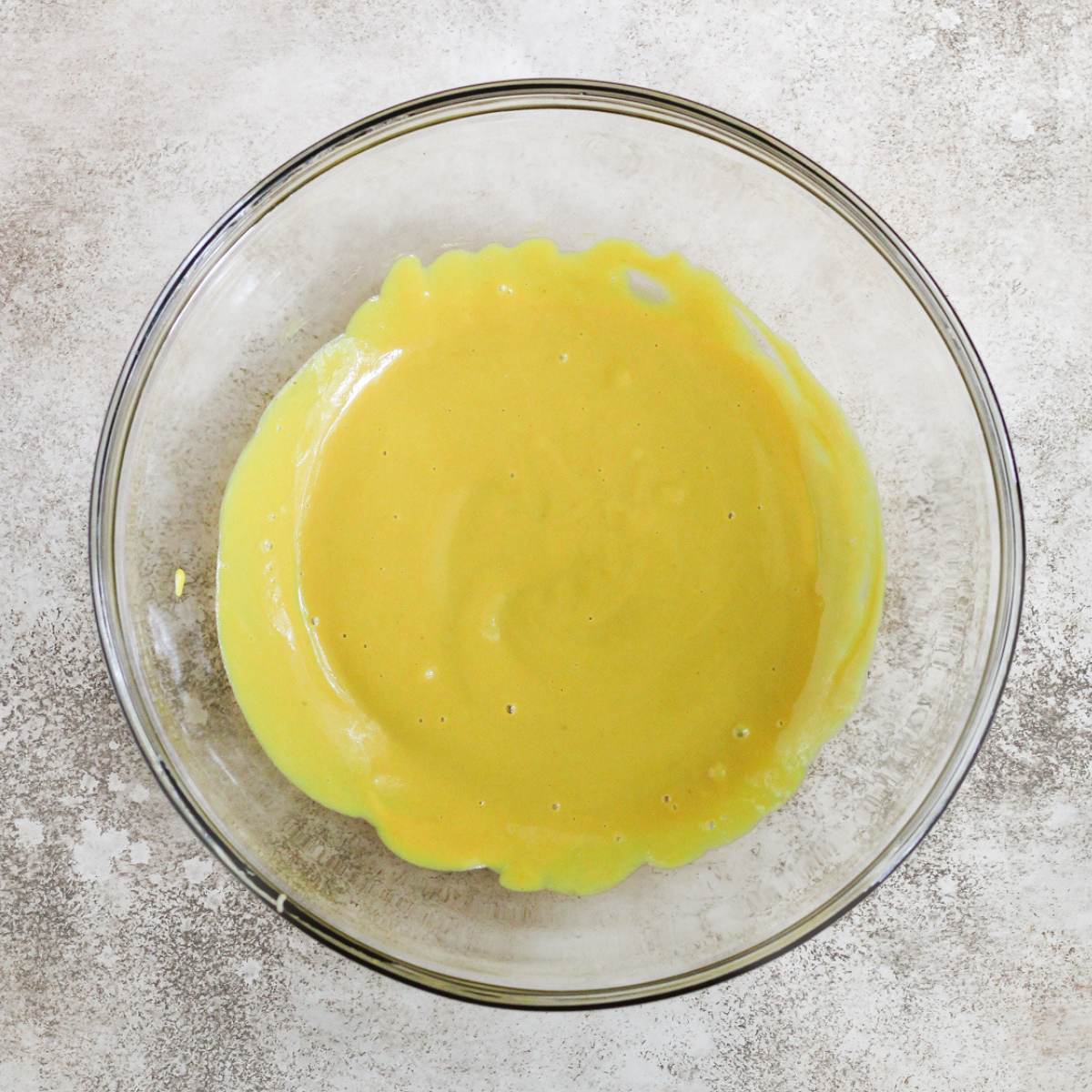 A glass bowl with honey mustard inside.