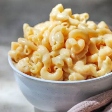 A white bowl filled with high protein mac and cheese.