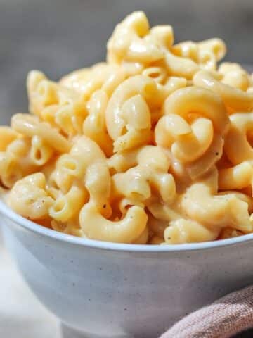 A white bowl filled with high protein mac and cheese.